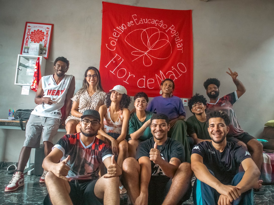 A group of people poses with a banner.