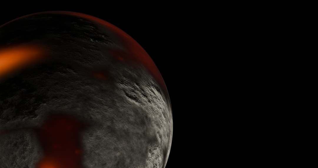 A dark, textured planet with glowing red lava flows.