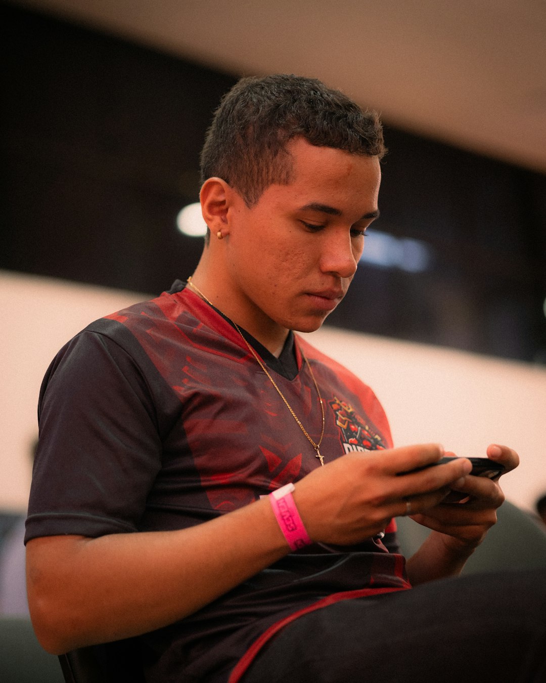 Young man playing a video game on his phone.