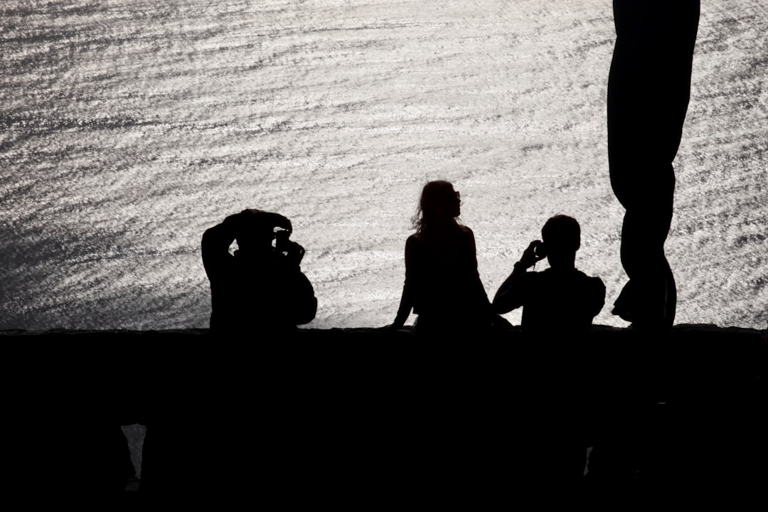 Silhouettes of people against a textured background.