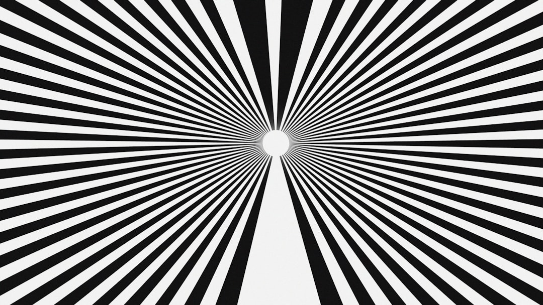 Black and white radiating lines with a central white oval.